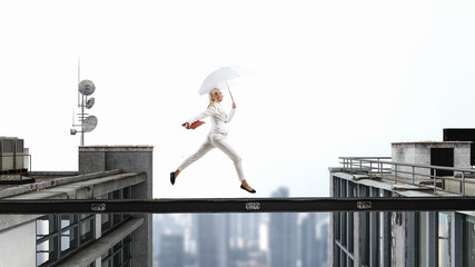 Fearless businesswoman overcoming difficulty. Mixed media