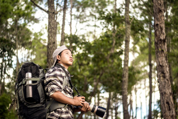 Fototapeta premium Young photographer at happy sunny day outdoor photo session in forest