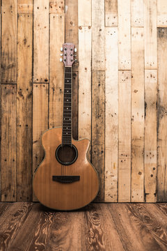 acoutic guitar on vintage wood background with copy space.