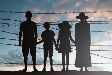 Silhouette Of Refugee Family