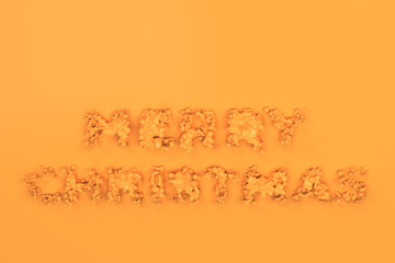 Liquid orange Merry Christmas words with drops on orange background