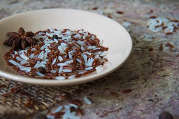 Red and white rice with spices. Raw asian rice