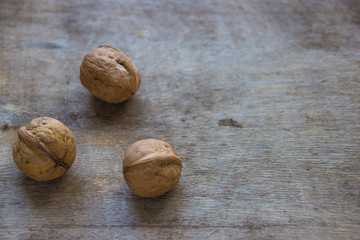 Walnuts on wooden table. Whole fresh walnuts