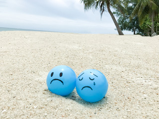 Feeling blue sad face on blue ball with summer beach view