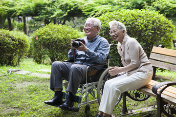 An old couple is taking pictures so fun