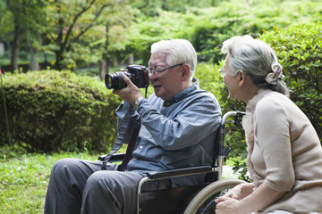 An old couple enjoying a camera of hobby