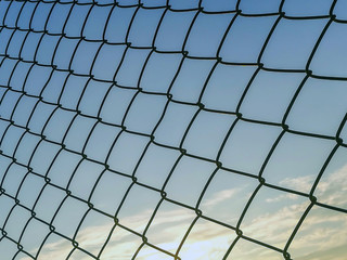 Abstract image of iron fence with sky on the evening or sunset time.