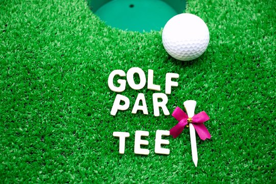 Golf Party Invitation With Golf Ball And Wording Are On Green Grass Next To Golf Hole