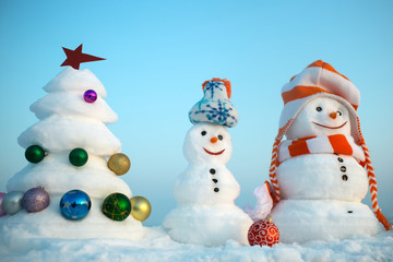 Snowmen on blue sky background