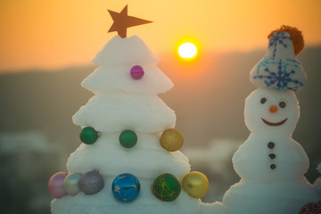 Snow sculptures on sunset sky background