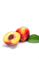 Fototapeta na wymiar One and a half nectarine peaches isolated on white background