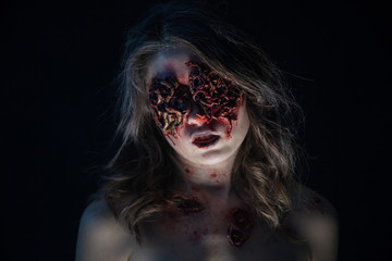 Portrait of a girl with realistic ulcers and worms crawling out of her eyes. creative halloween...