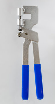 Punch lock crimper isolated on grey background. Instrument for drywall.