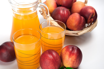 juice and fresh peaches  on white background
