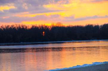 Bright sunset over a river Dnieper on winter