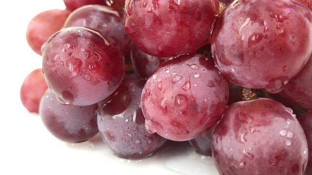 Big view: A lot Red Grapes White background wet water droplet, authentic motion rain water droplets natural fruti