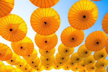 Fototapeta na wymiar Pattern Yellow umbrellas on blue sky.