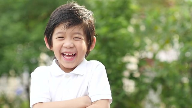 Close up of happy asian child dancing outdoor slow motion 