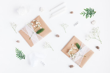 Fototapeta na wymiar Christmas composition. Christmas gifts, pine cones, gypsophila flowers, thuja branches on white background. Flat lay, top view