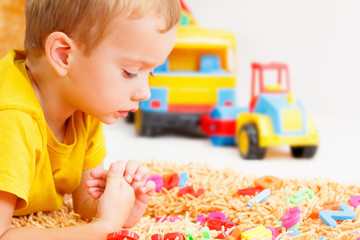 Child playing with letters beginning of the year.