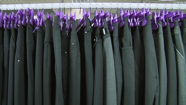 Old-fashioned ugly horrible women clothing on rack in collective farm Uryupinsk. Anti-advertising. How not to do.