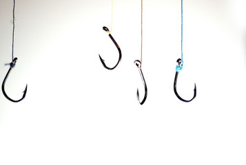 Many fishing hooks hang together.