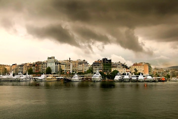 Fototapeta premium Rainy day with cloudscape.Luxury Yachts in a row at marina Zeas in Pasalimani, Piraeus port