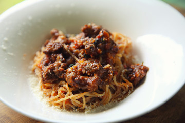 Beef stew spaghetti on wood background