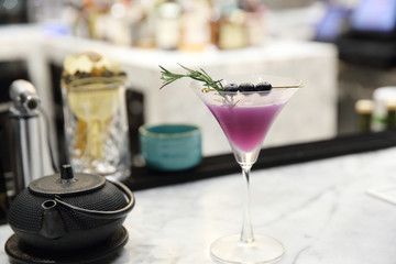 Purple cocktail on bar background