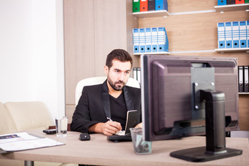 Businessman working in his office. Businessperson in professional environment