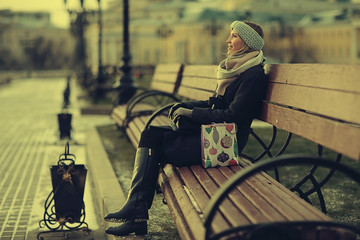 woman on a bench in a winter city