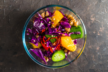 Salad of vegetables and fruits in a glass bowl