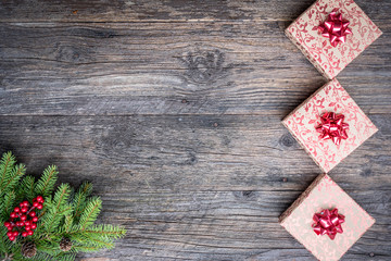 Christmas background with decorations and gift boxes on old rustic black wooden board, top view, copy space