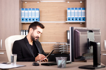 Happy Businessman working in his office. Businessperson in professional environment
