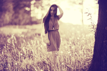 Summer sunny park portrait of a beautiful young woman