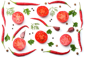 mix red hot chili peppers with parsley and sliced tomato isolated on white background top view