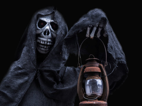 Human skull hold the lantern. Halloween day or Ghost festival, Ghost on suit.