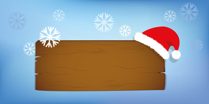 holzschild mit weihnachtsm&uuml;tze im schnee