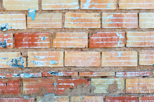 brick wall with remains of glued signs