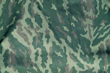 Green and brown military camouflage uniform pattern.