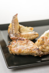 Fried chicken wings served on the black plate