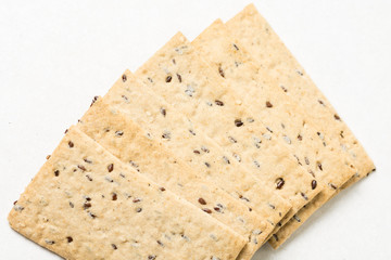 Flax chips isolated above white marble background table