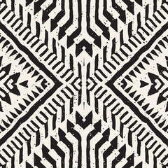 Black and white tribal vector seamless pattern with doodle elements. Aztec abstract art print. Ethnic ornamental hand drawn backdrop.