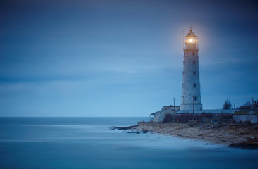 Seascape at sunset. Lighthouse on the coast