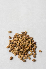 Pile of soya beans isolated above white marble background with copy space