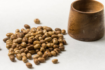 Soya beans with wooden pot on the white marble background