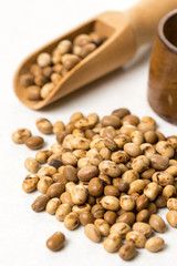 Pile of soya beans with wooden spoon on the white marble background table