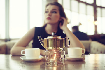 girl drinks tea in a restaurant