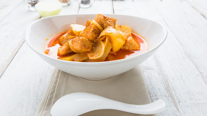 Massaman pork curry on wood background. Coconut milk curry.