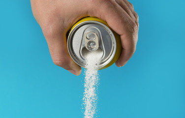 man hand holding refresh drink can pouring sugar stream in sweet and calories content of soda and...